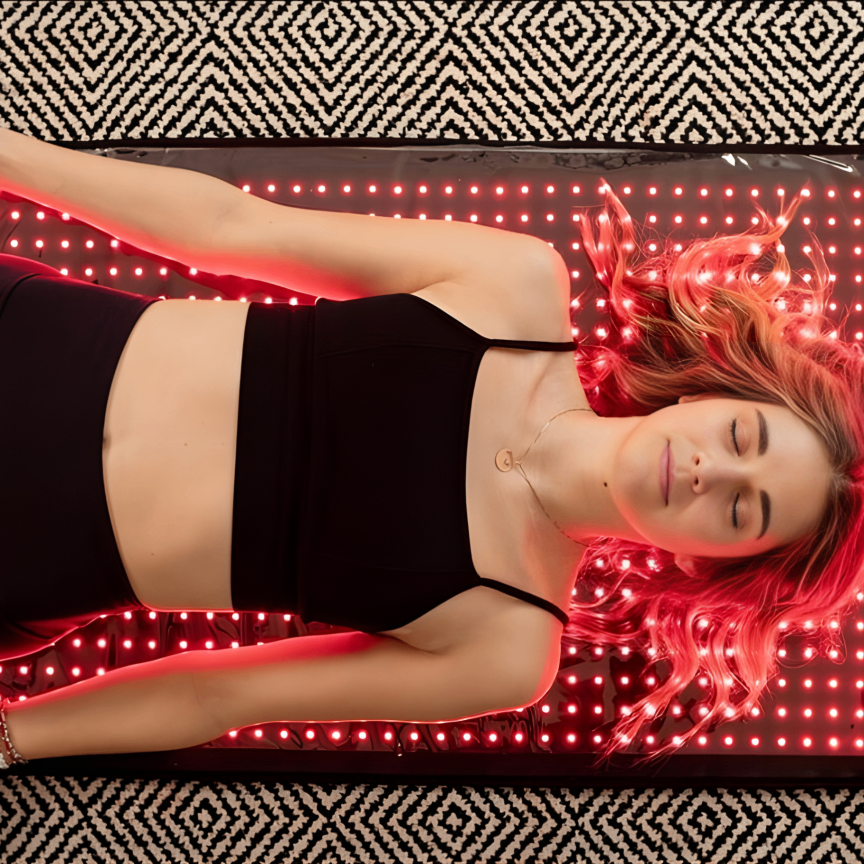 Woman relaxing on Filoriya red light therapy mat
